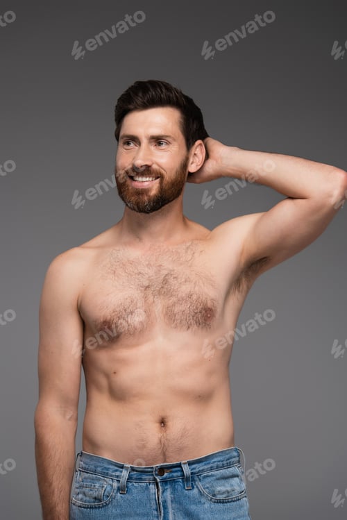 Preview: shirtless and bearded man looking away while smiling isolated on grey