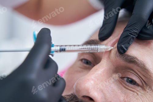Preview: Close up of male person doing anti-wrinkles injection
