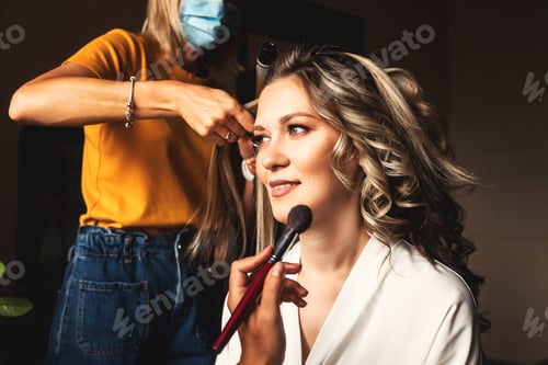 Preview: Hairdresser make hairstyle for pretty woman at morning. Make-up artist make wedding makeup