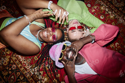 Preview: Top View Three Trendy Young People Lying on Carpet