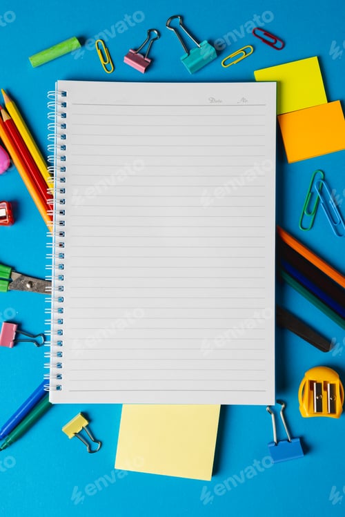 Preview: Vertical composition of school equipment with notebook with copy space on blue surface