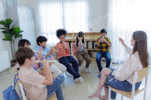 Preview: Diversity of elementary students learning in classroom music lesson with recorders