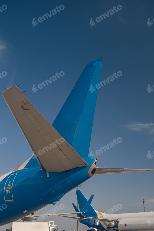 Preview: Aircraft tail of international airlines in airport with blue sky in the background