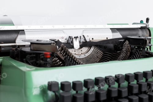 Preview: Vintage green typewriter with visible mechanism in a bright setting