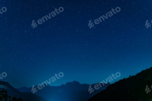 Preview: Majestic night sky illuminating mountain range with twinkling stars