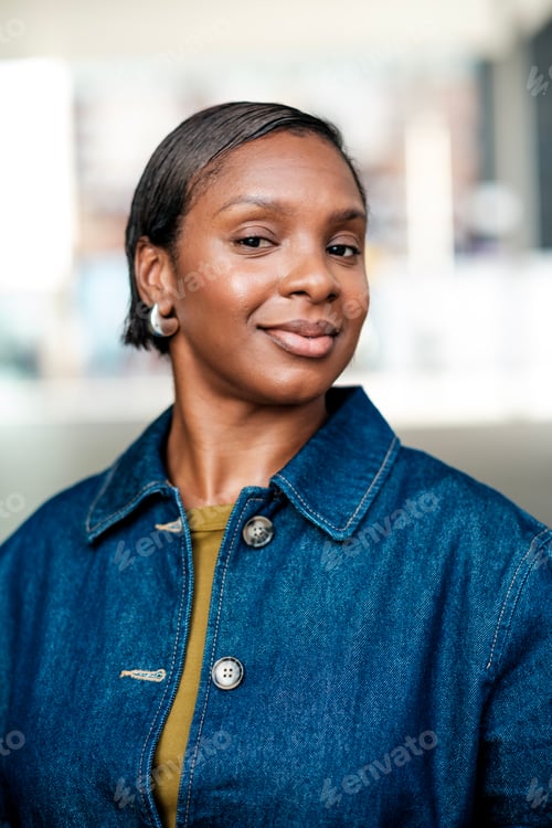 Preview: Confident black businesswoman smiling in modern office environment