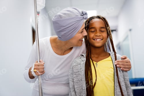 Preview: Sick woman with cancer hugging her young grandchild in hospital. Family support concept