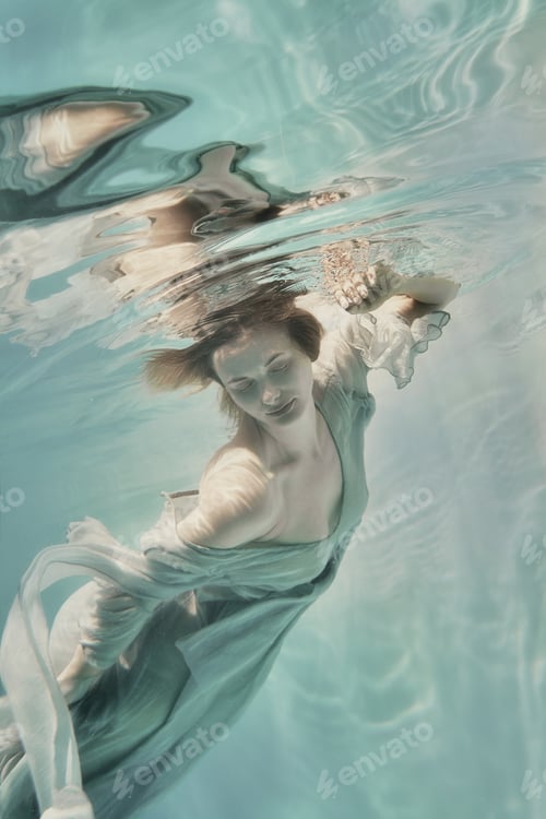 Preview: A Girl In An Airy Light Dress Swims Underwater As If Flying In Zero Gravity
