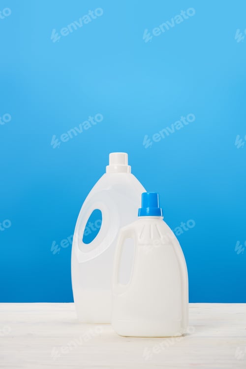Preview: plastic containers with laundry liquids on blue