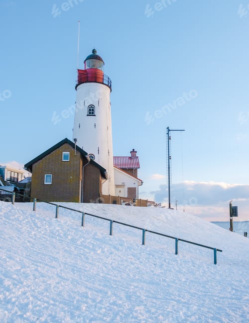 Preview: Lighthouse of Urk during winter with snow in the Netherlands on a cold day in winter