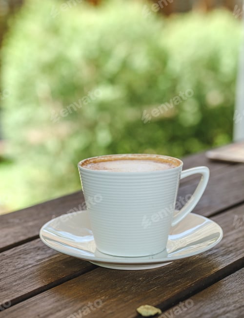 Preview: hot coffee cup on table in garden