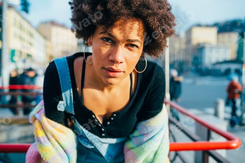 Preview: Portrait young curly hair black woman outdoor posing looking camera smiling