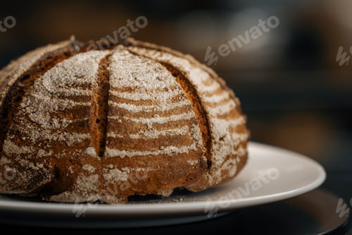 Preview: Close-up, bakery - freshly baked dark bread on rotating surface