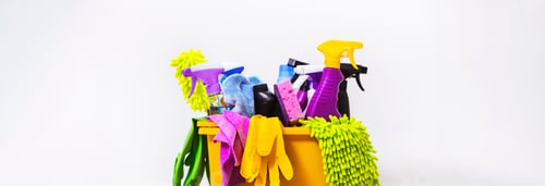 Preview: Bright multi-colored cleaning products, household chemicals bottles and sprays, rags, sponges