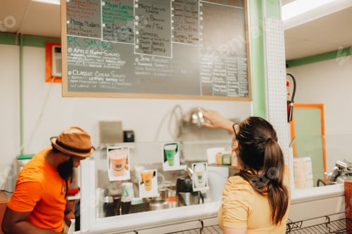 Preview: Young millennial woman shopping at a local small black owned business, convenience store, menu items