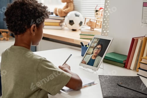 Preview: Boy making notes while listening to lecture