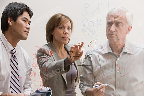 Preview: People looking at diagram on glass wall