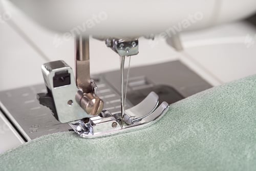 Preview: Modern Sewing Machine Presser Foot With Green Fabric And Thread, Closeup, Macro