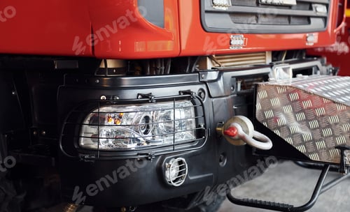Preview: Close up view of front part of red fire truck. Natural lighting
