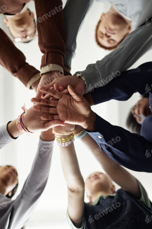Preview: From Below Group of Children Stacking Hands