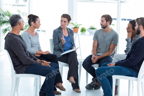 Preview: Group Therapy In Session Sitting In A Circle In A Bright Room