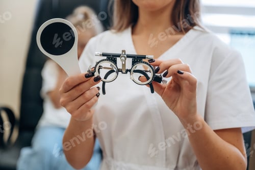 Preview: Little girl at the ophthalmologist clinic with doctor