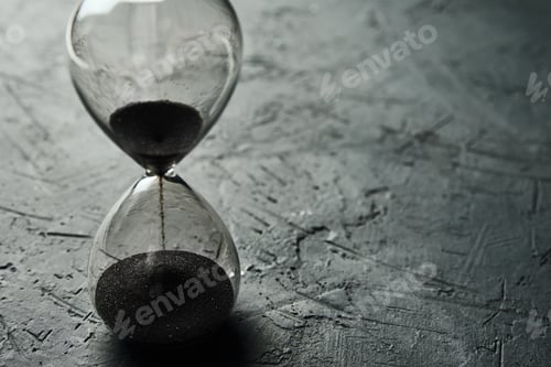 Preview: Hourglass on dark background, closeup. Urgency and running out of time concept
