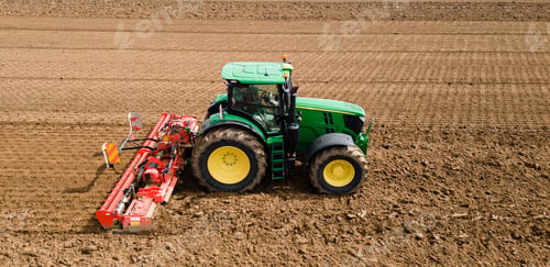 Preview: A farmer using a tractor to prepare the fields for planting. The image highlights the importance of