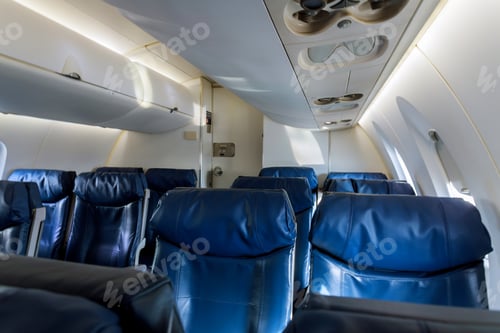 Preview: Armchairs in passenger cabin, with safety belts Aircraft seats and window.