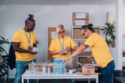 Preview: Group of multiracial volunteers working in community charity donation center