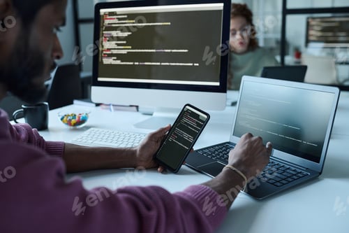 Preview: Programmer connecting smartphone with laptop