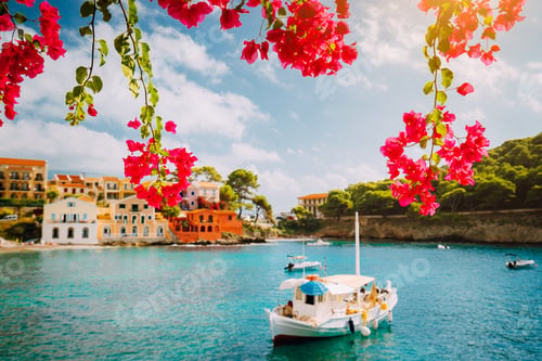 Preview: Kefalonia Greece Assos village, fishing boat in tranquil bay and magenta fuchsia blossom