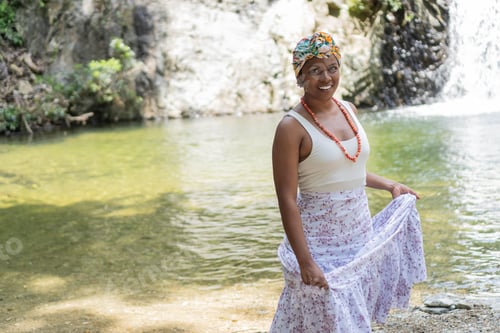 Preview: Portrait of Black woman standing by the river
