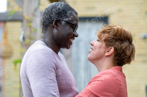 Preview: Mixed race parents embrassing in a tender loving hug. joy and passion