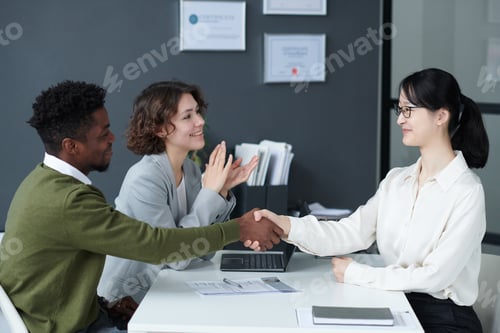 Preview: Business Handshake Meeting with Smiling Colleagues Indoors