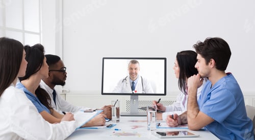 Preview: Doctors Having Online Video Call Conference At Computer In Office
