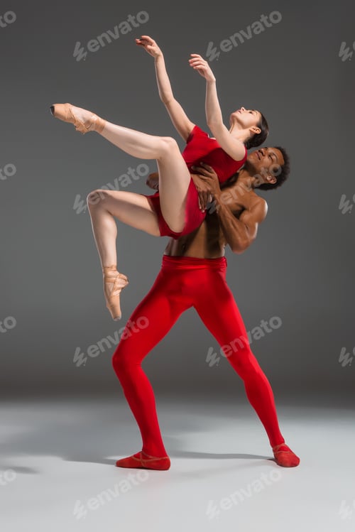 Preview: Couple of ballet dancers posing over gray background
