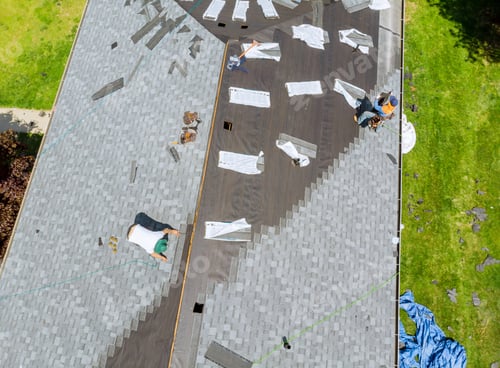 Preview: Roofer working on replacement asphalt shingle roof construction