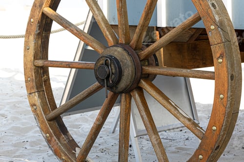 Preview: Closeup image of a vintage carriage wheel.