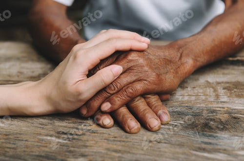 Preview: Young man holding senior woman hands, closeup