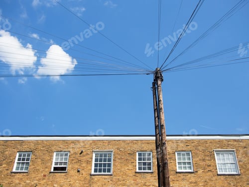 Preview: Low angle view telephone pole and building against sky
