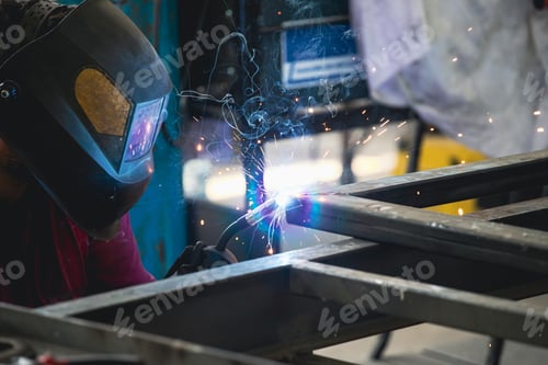 Preview: Industry worker welding iron pieces at work