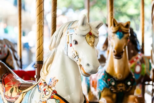 Preview: Vintage french carousel horse closeup in fair park. Merry-go-round horses in amusement fun park for