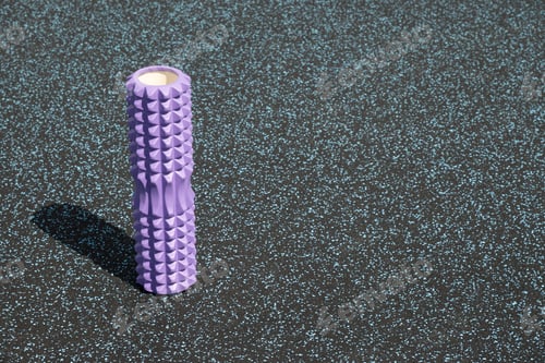 Preview: Violet foam roller on sports ground for pilates. Outdoor workout. Ready for morning routine