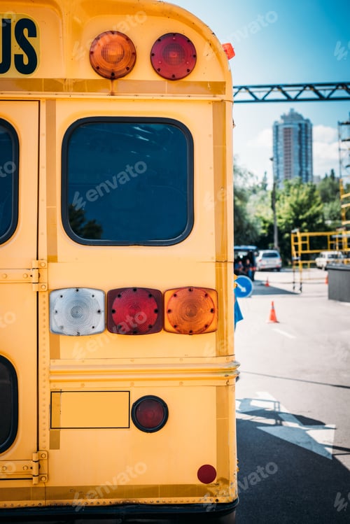 Preview: rear view of school bus back lights standing on parking