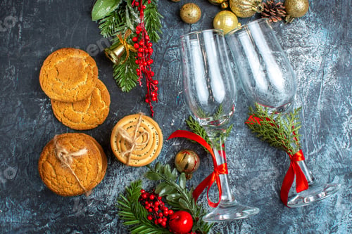Preview: Horizontal view of glass goblets decoration accessories stacked cookies on dark background