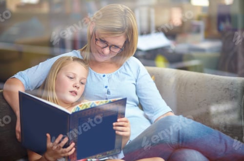 Preview: My favorite book. A cute young girl sitting next to her mother while they read a book.