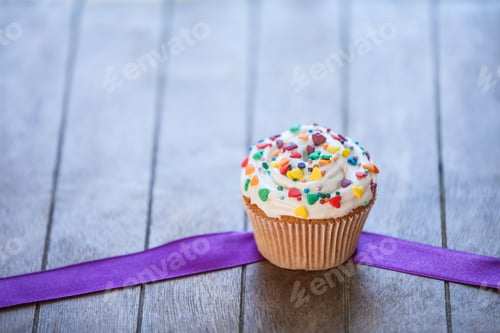 Preview: Festive Cupcake with Sprinkles on Wooden Table