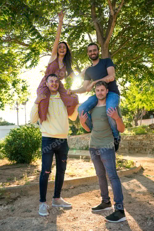 Preview: Happy friends standing on each other's shoulders