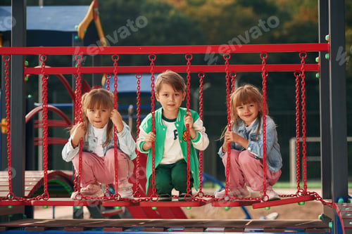Preview: One boy and two girls. Kids are having fun on the playground
